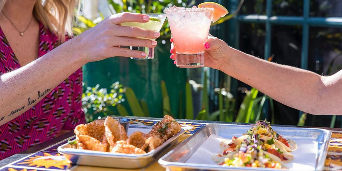 Friends Toasting Over Table of Tacos at LaCo