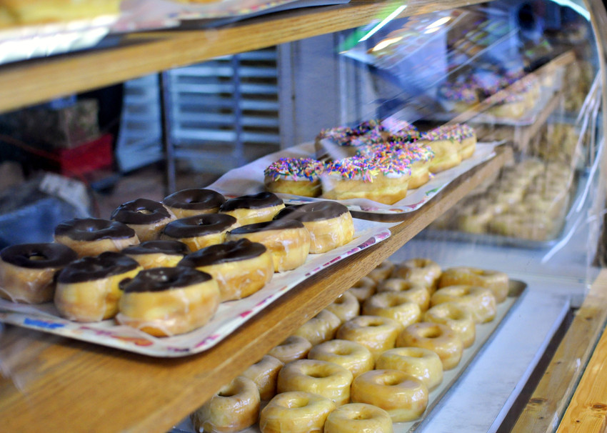 Variety of Donuts in Glass Case